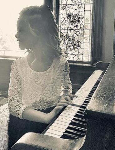 Novalee Reign Baltierra playing piano